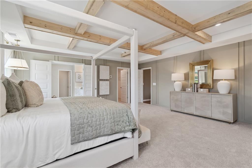 412 Hartsfield Road McDonough, GA 30252 - Photo 37 of 43 a bedroom with a large bed and a chandelier