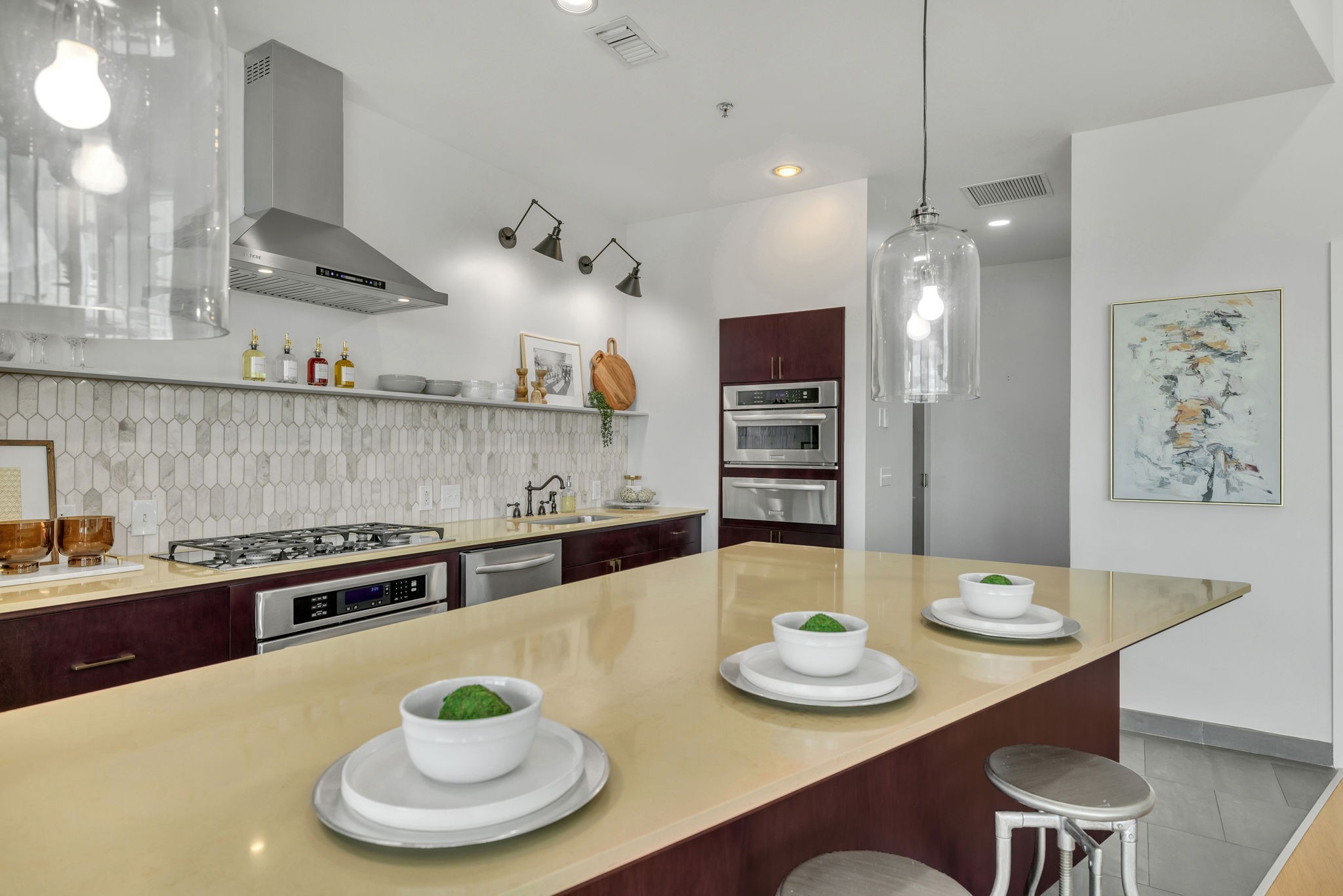 a kitchen with stainless steel appliances a dining table and chairs