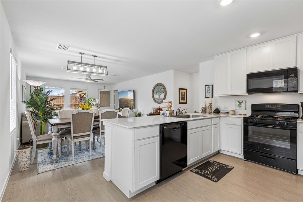 14163 Kempt Drive Pilot Point, TX 76258 - Photo 7 of 29 The open-concept design allows the kitchen to flow effortlessly into the dining and living areas, creating a bright and welcoming space that's perfect for entertaining or everyday living.