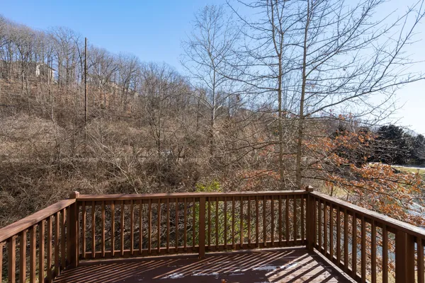 a view of balcony with wooden floor and fence