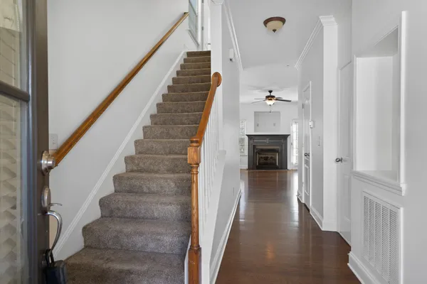 a view of entryway and hall with wooden floor