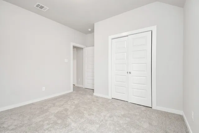 an empty room with closet area