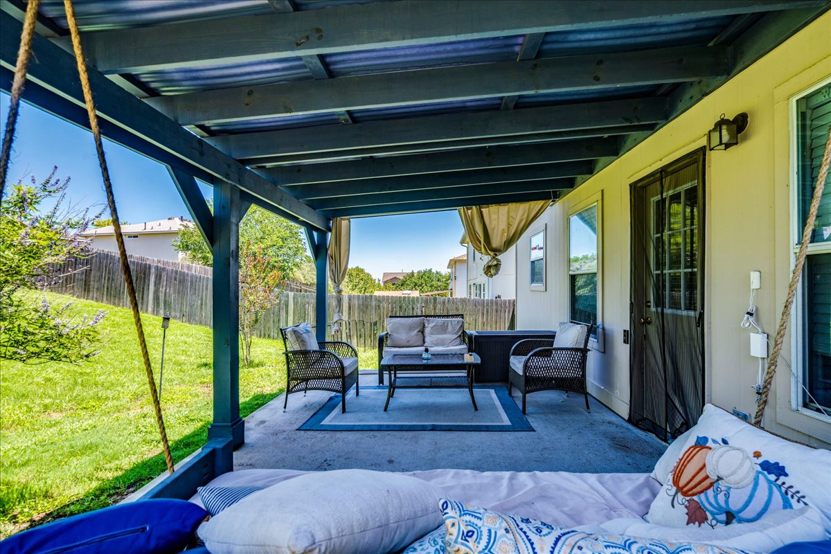 148 Buttercup Way Kyle, TX 78640 - Photo 26 of 33 An inviting covered patio offers a comfortable outdoor living space overlooking the fenced yard.