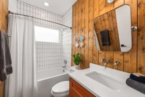 a bathroom with a sink a toilet and bathtub