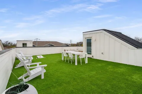 a view of a garden with lawn chairs