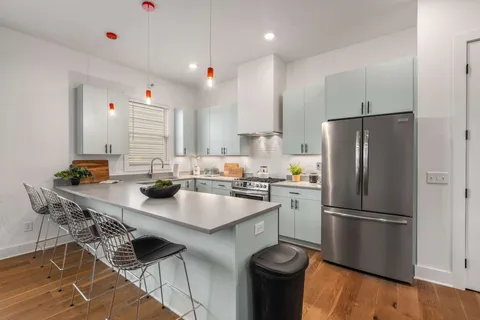 a kitchen with appliances cabinets and a table