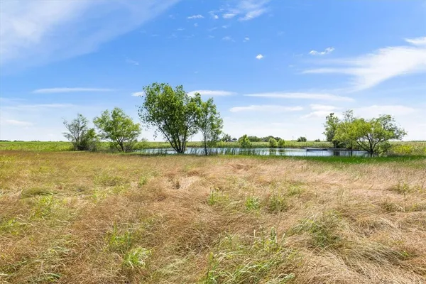 a view of a lake with a yard