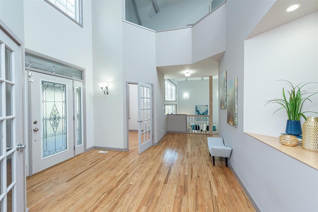 Foyer opens to 2 office spaces and two story ceiling overhead. Foyer