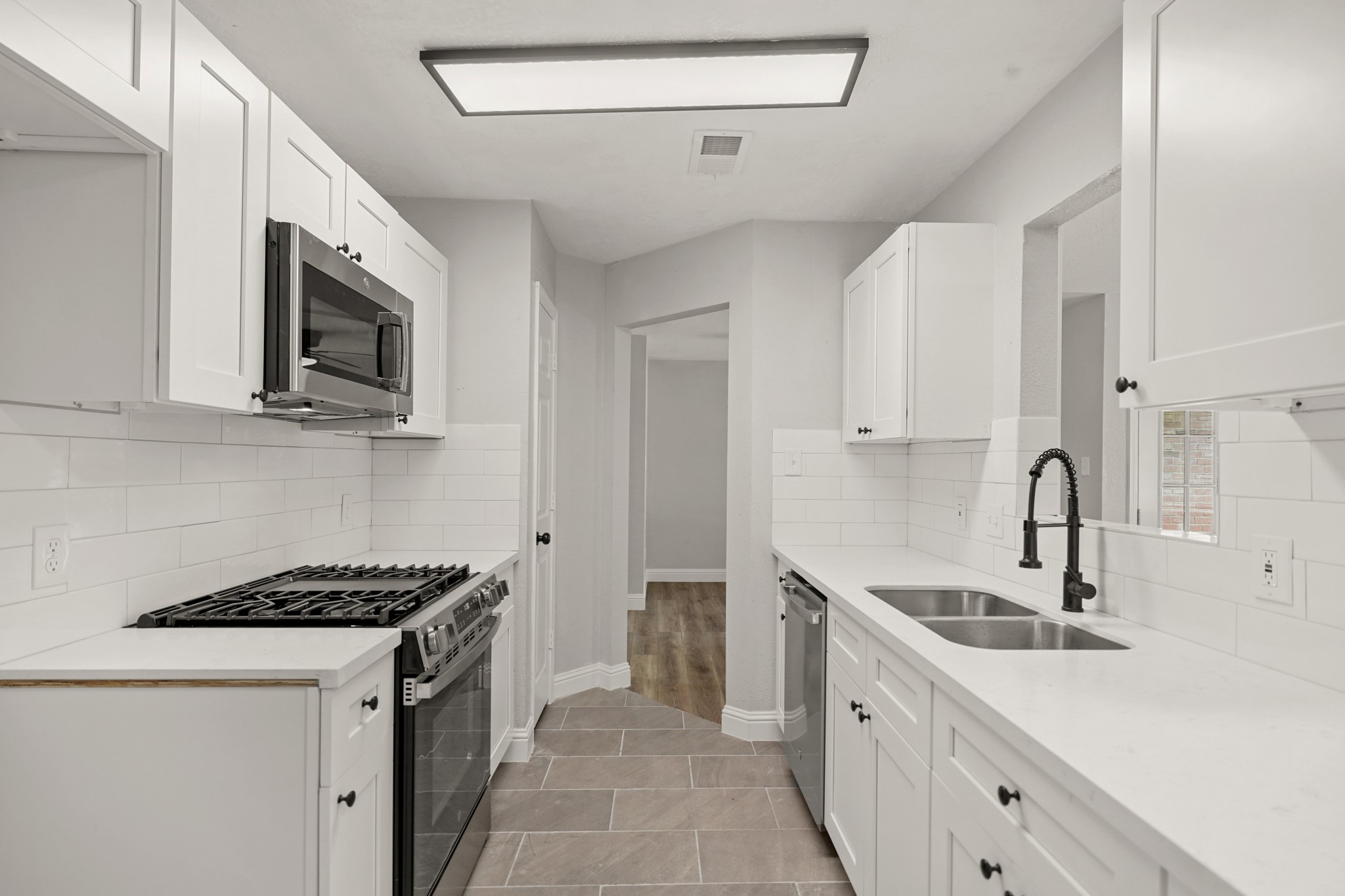 3623 Peachstone Place Spring, TX 77389 - Photo 10 of 20 a kitchen with stainless steel appliances granite countertop a sink stove top oven and refrigerator