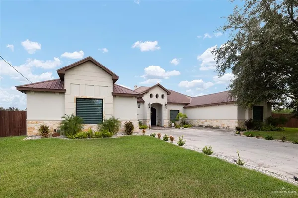 a front view of house with yard and trees