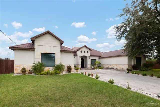 a front view of house with yard and trees