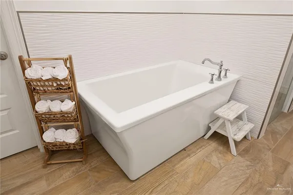 a view of a patio with table and chairs potted plants with wooden floor and fence