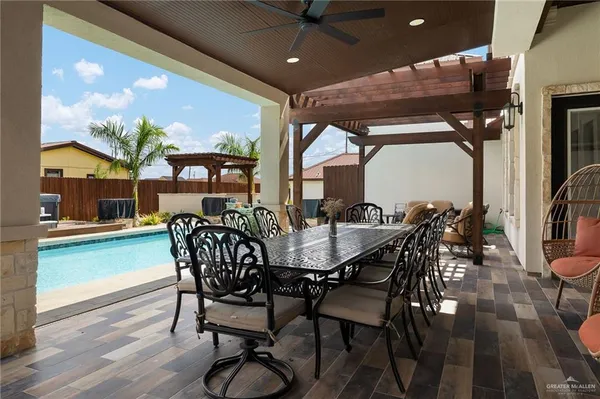 a kitchen with stainless steel appliances kitchen island granite countertop a sink counter top space and a view of dining room