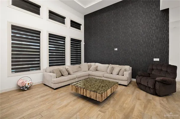 a living room with furniture and a flat screen tv