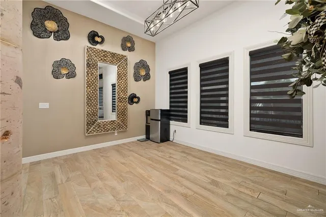 a kitchen with kitchen island granite countertop a sink appliances cabinets and a counter top space