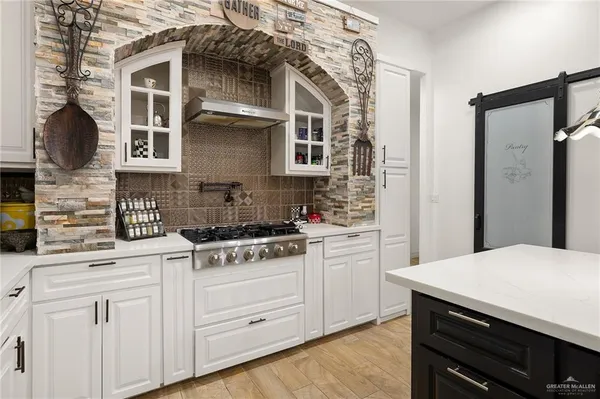 a bathroom with a double vanity sink a large mirror and a bathtub