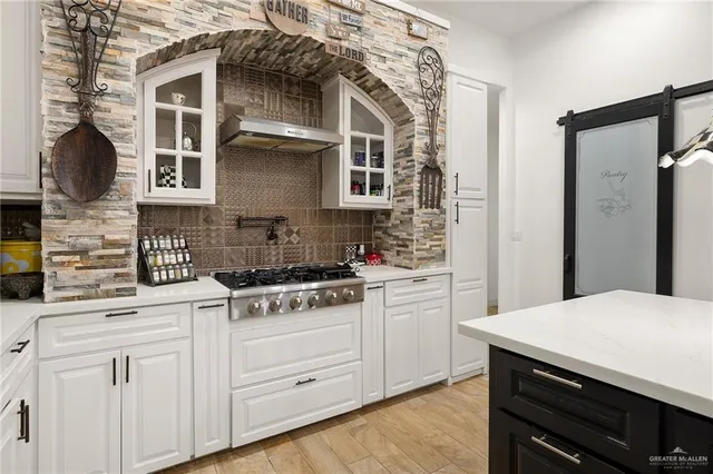 a bathroom with a double vanity sink a large mirror and a bathtub