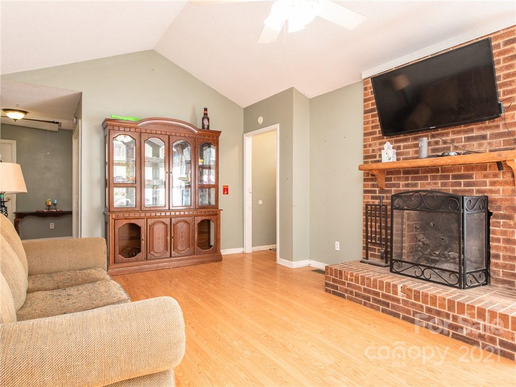 128 Altan Ridge Drive Monroe, NC 28112 - Photo 11 of 42 a living room with furniture a flat screen tv and a fireplace