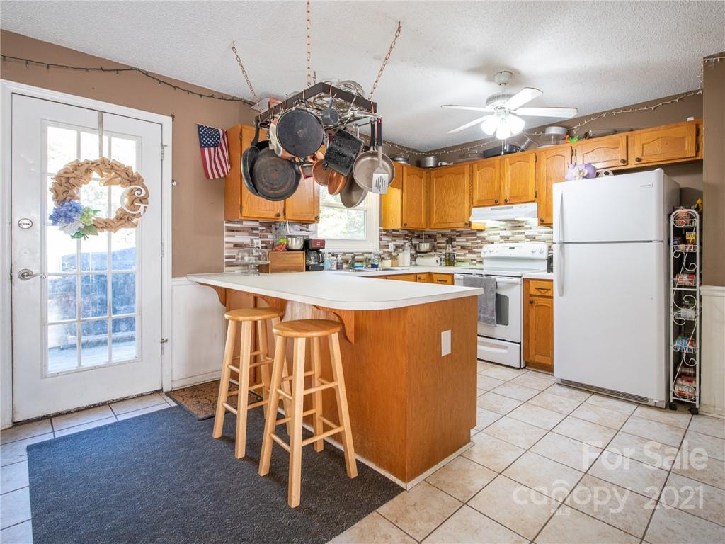128 Altan Ridge Drive Monroe, NC 28112 - Photo 15 of 42 a kitchen with stainless steel appliances granite countertop a stove a sink a refrigerator and a dining table