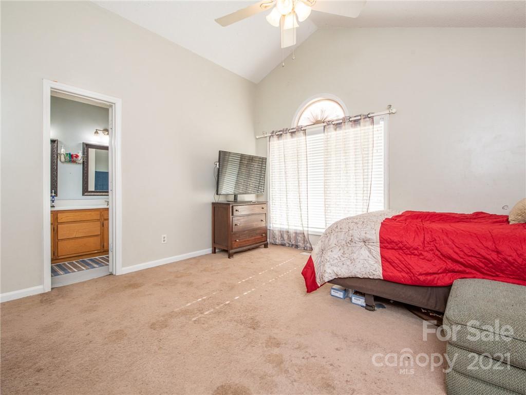 128 Altan Ridge Drive Monroe, NC 28112 - Photo 21 of 42 a bedroom with a bed and a view of walk in closet