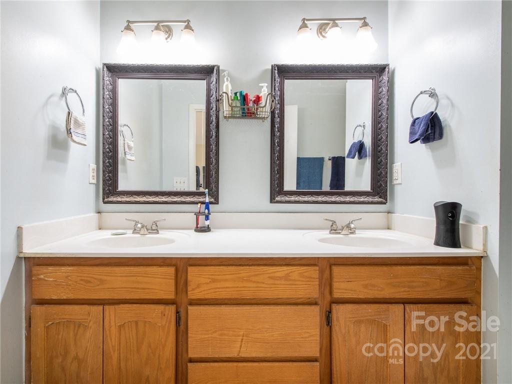128 Altan Ridge Drive Monroe, NC 28112 - Photo 22 of 42 a bathroom with a double vanity sink and a mirror