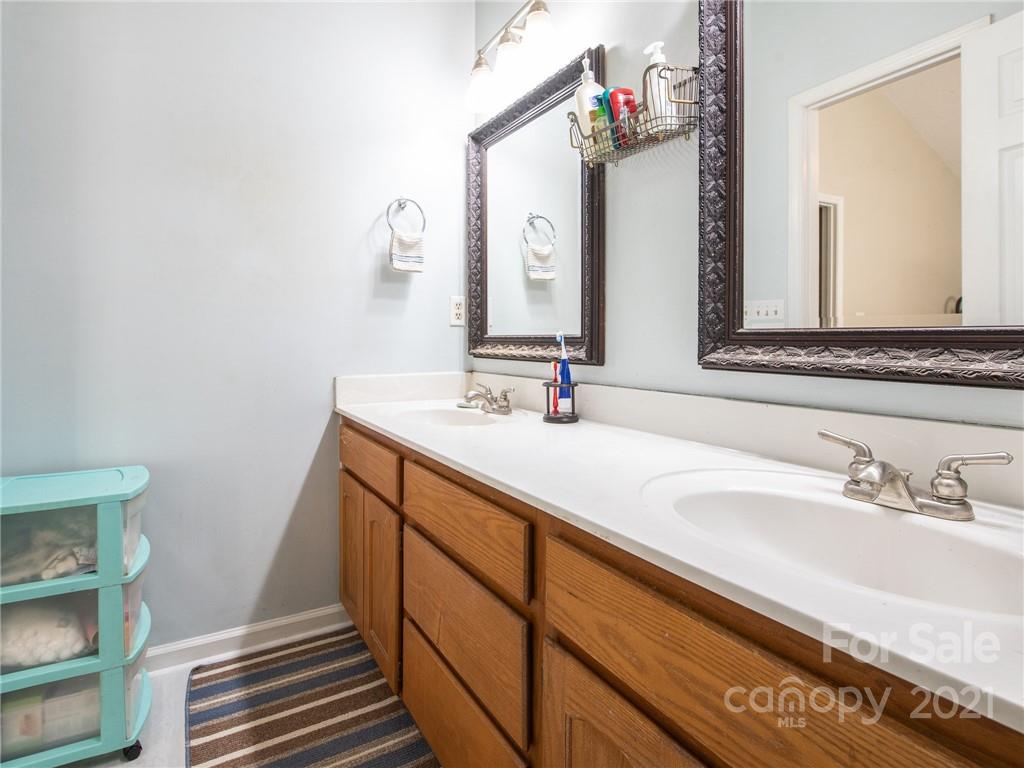 128 Altan Ridge Drive Monroe, NC 28112 - Photo 23 of 42 a bathroom with a sink and a mirror