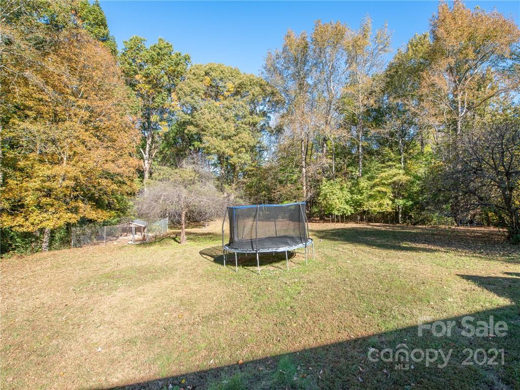 128 Altan Ridge Drive Monroe, NC 28112 - Photo 30 of 42 a swimming pool with trees in the background