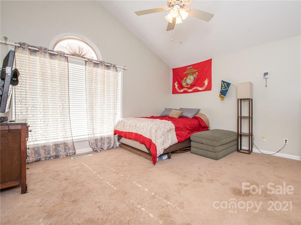128 Altan Ridge Drive Monroe, NC 28112 - Photo 5 of 42 a bedroom with a bed and a chandelier