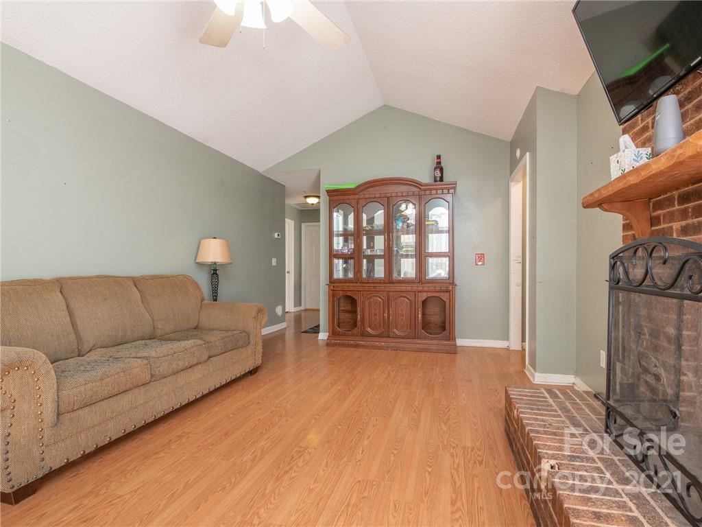 128 Altan Ridge Drive Monroe, NC 28112 - Photo 10 of 42 a living room with furniture a flat screen tv and a fireplace