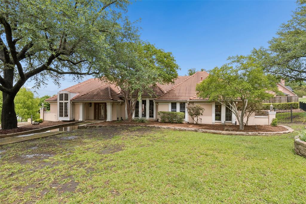 4 Eastshore Road Heath, TX 75032 - Photo 1 of 37 a front view of a house with a garden