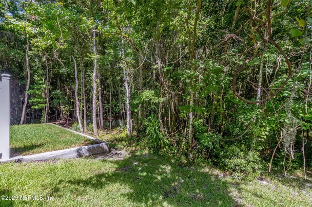 front view of a brick house with a yard