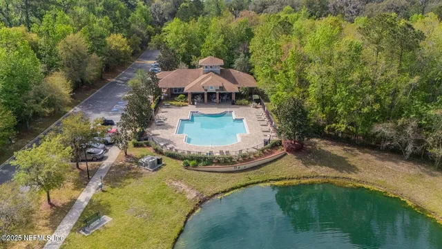 a swimming pool with trees in the background