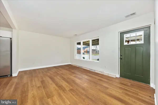 an empty room with windows and closet