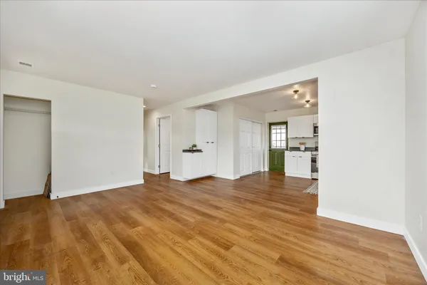 a view of empty room with wooden floor