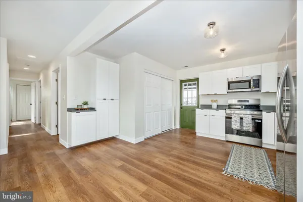 a kitchen with stainless steel appliances a refrigerator and a stove top oven
