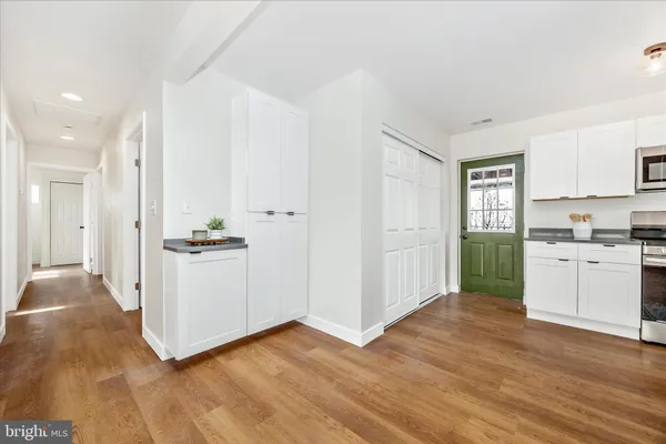 a view of a kitchen with wooden floor and a window