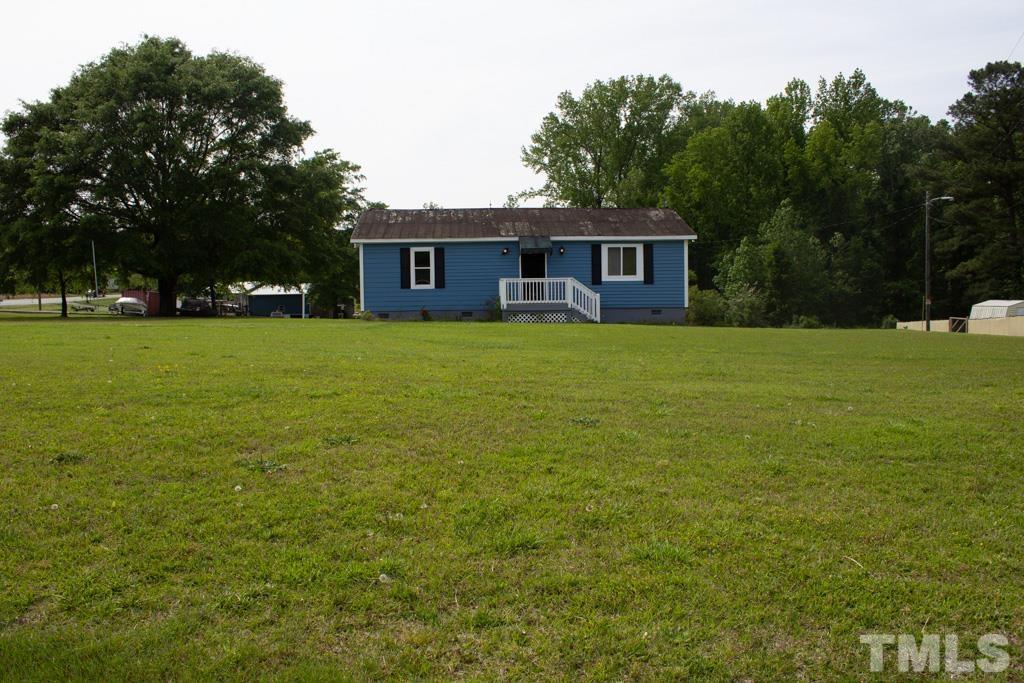 9592 Kennebec Road Willow Spring, NC 27592 - Photo 1 of 14 a brick house with a big yard and large trees
