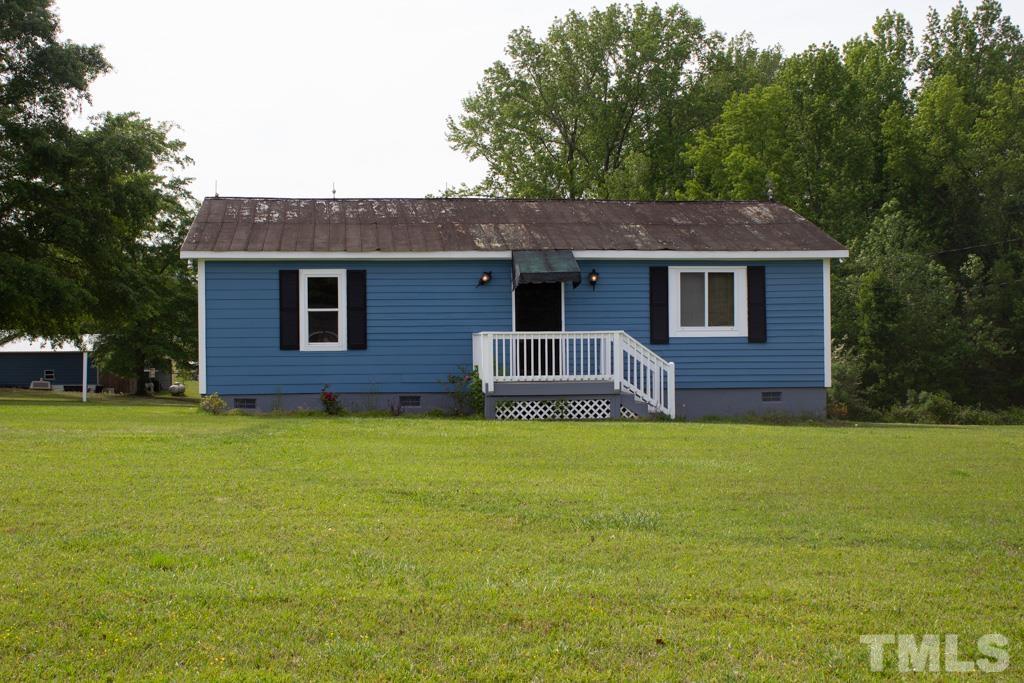9592 Kennebec Road Willow Spring, NC 27592 - Photo 2 of 14 a front view of a house with a garden