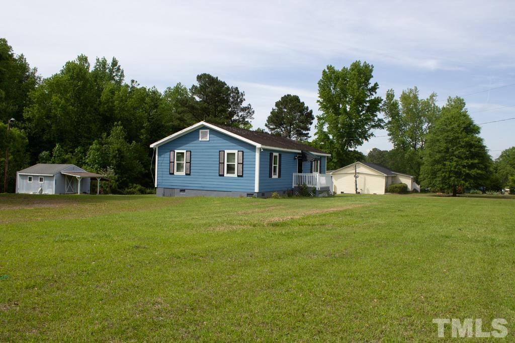 9592 Kennebec Road Willow Spring, NC 27592 - Photo 6 of 14 a front view of a house with a garden