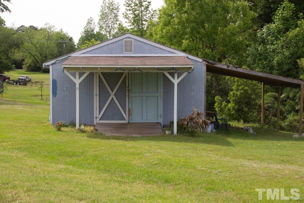 9592 Kennebec Road Willow Spring, NC 27592 - Photo 7 of 14 a view of a wooden house with a yard