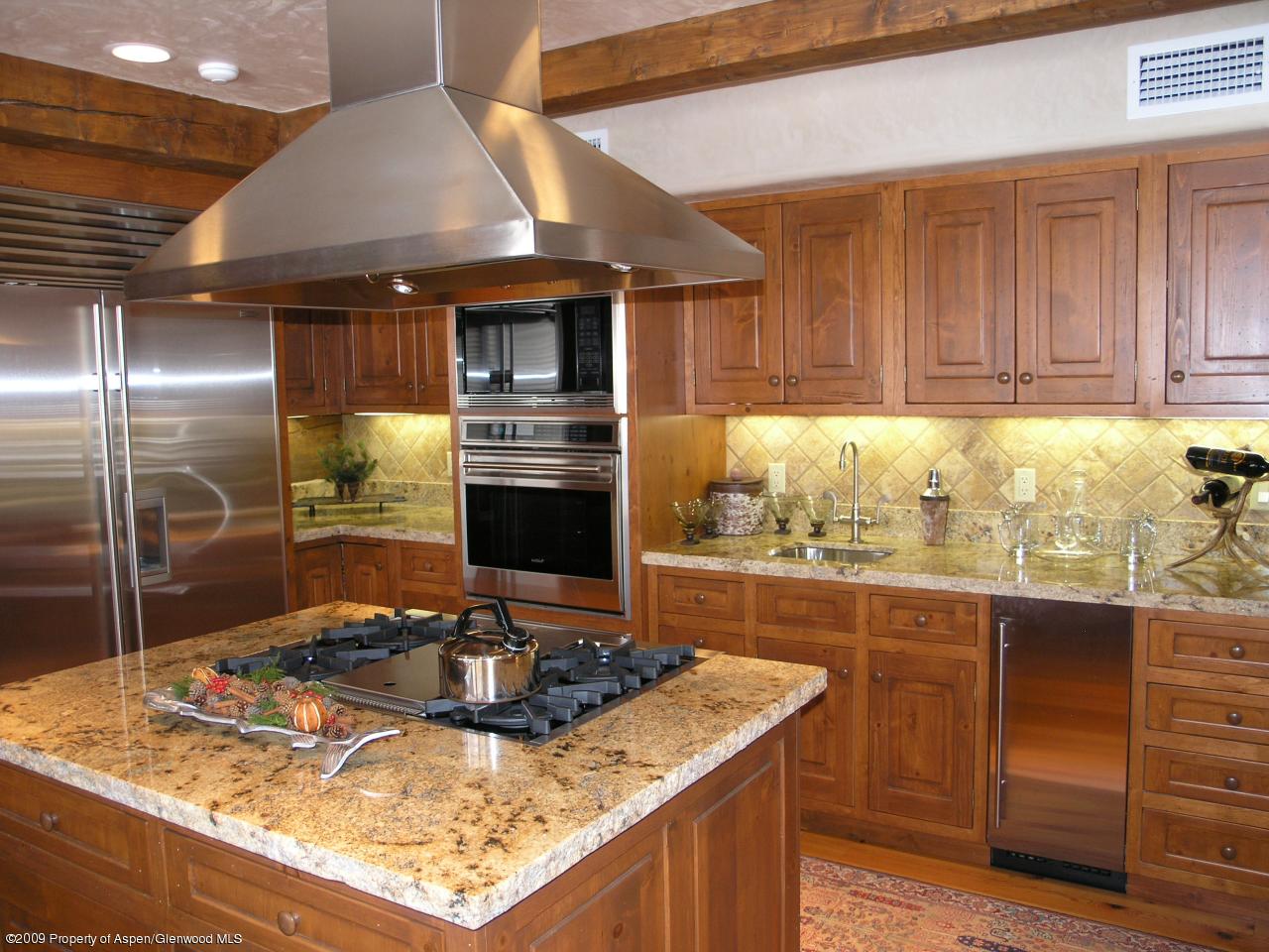 200 Altamira Ranch Road Basalt, CO 81621 - Photo 12 of 26 a kitchen with kitchen island granite countertop a sink stainless steel appliances and cabinets