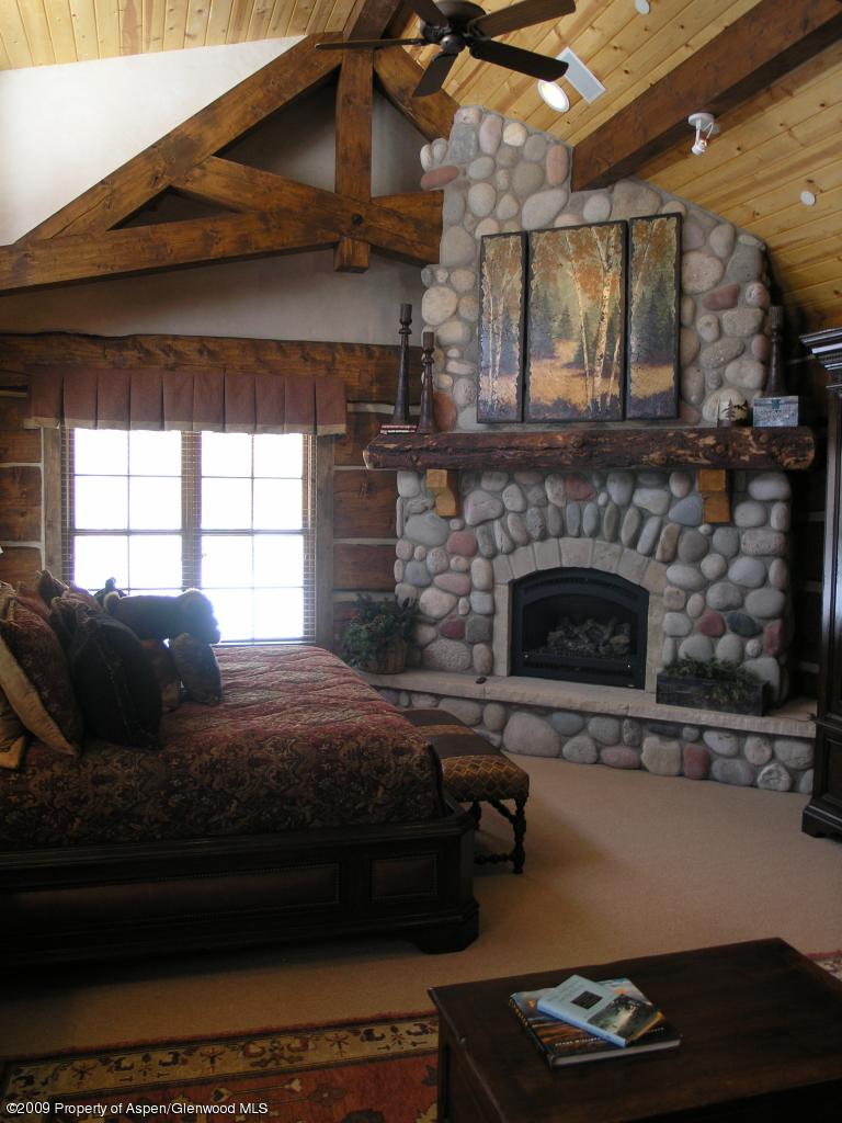 200 Altamira Ranch Road Basalt, CO 81621 - Photo 16 of 26 a living room with furniture and a fireplace