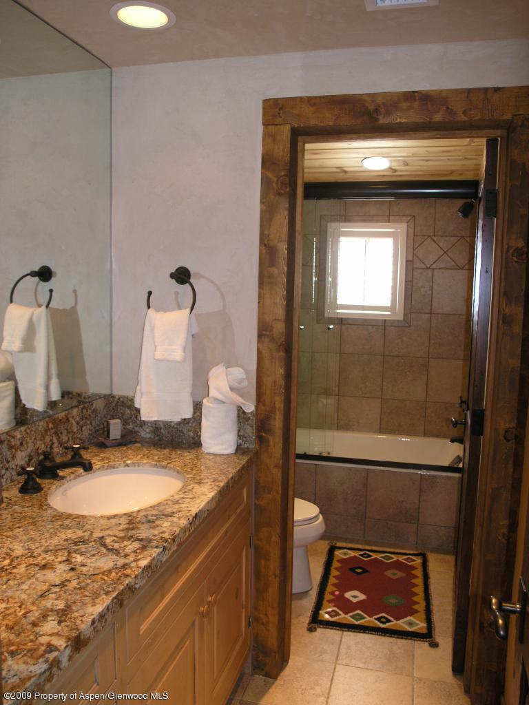 200 Altamira Ranch Road Basalt, CO 81621 - Photo 23 of 26 a en suite bathroom with a granite countertop sink and a mirror
