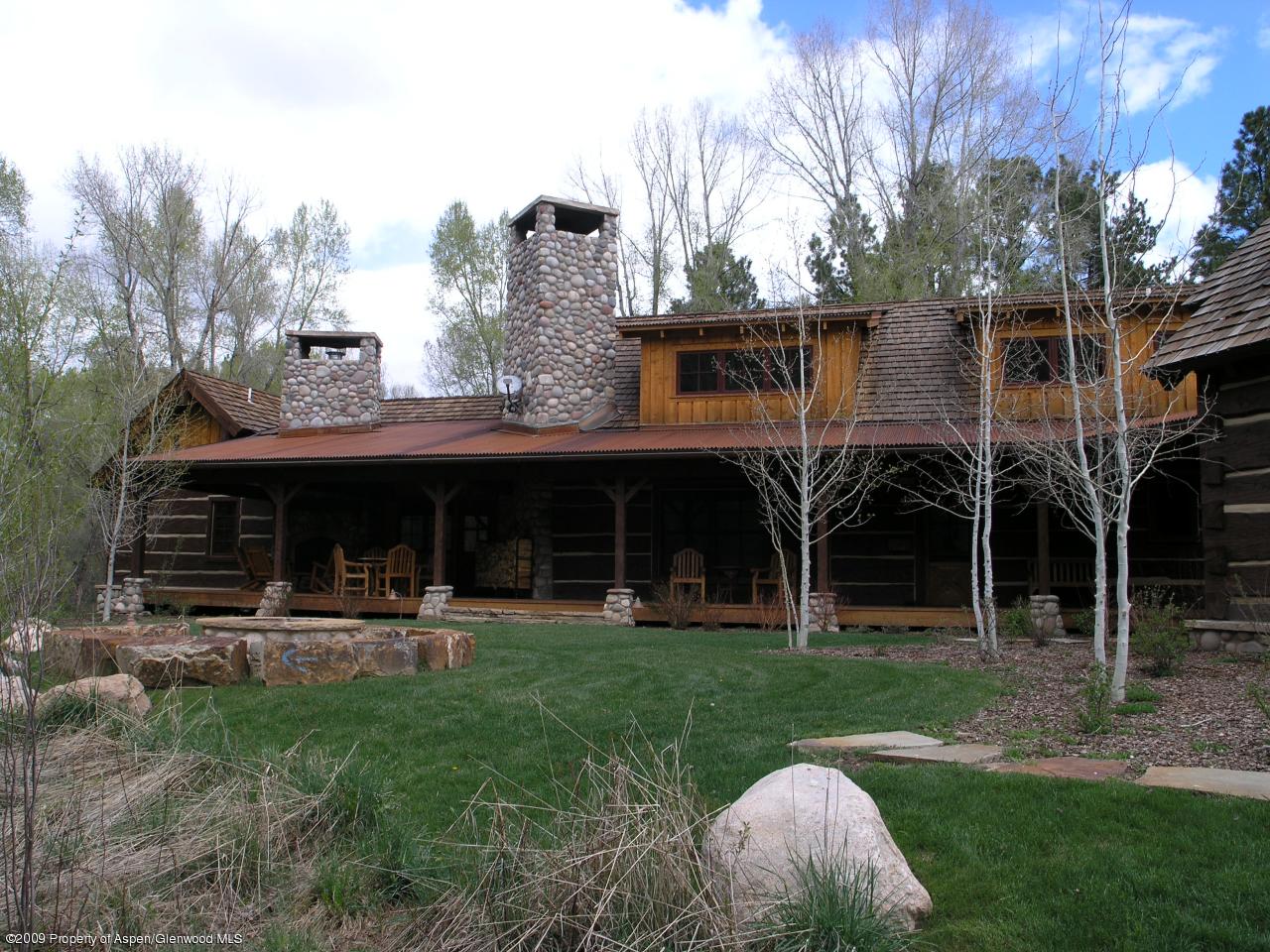 200 Altamira Ranch Road Basalt, CO 81621 - Photo 4 of 26 a front view of a house with garden and trees