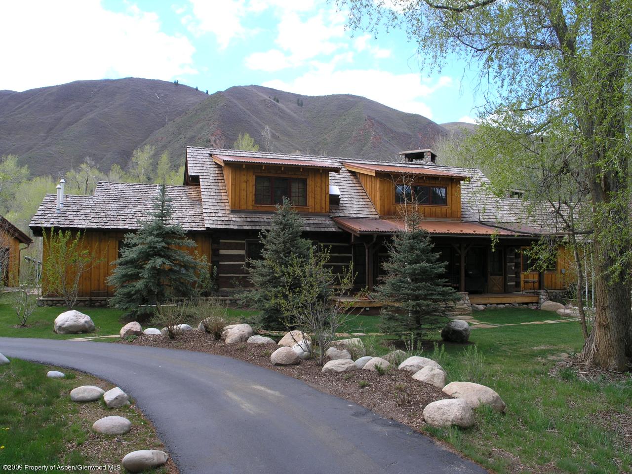 200 Altamira Ranch Road Basalt, CO 81621 - Photo 5 of 26 a front view of a house with a yard and a large tree