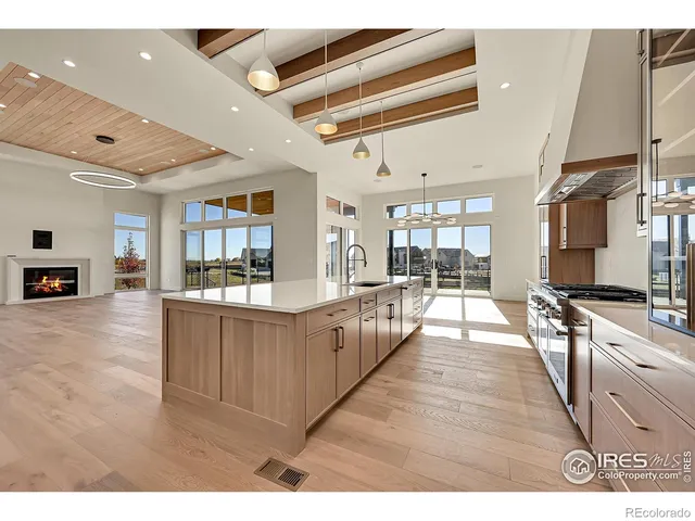 a large white kitchen with lots of counter space and window