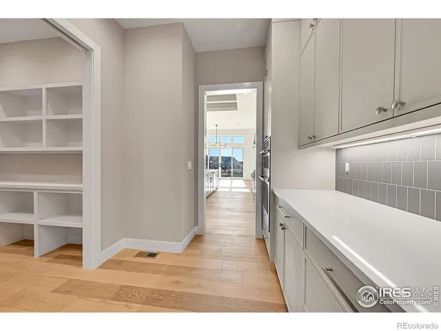 a view interior of kitchen and hall with wooden floor
