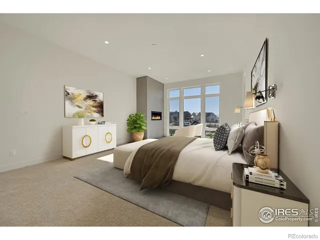 a living room with furniture a large window and a potted plant