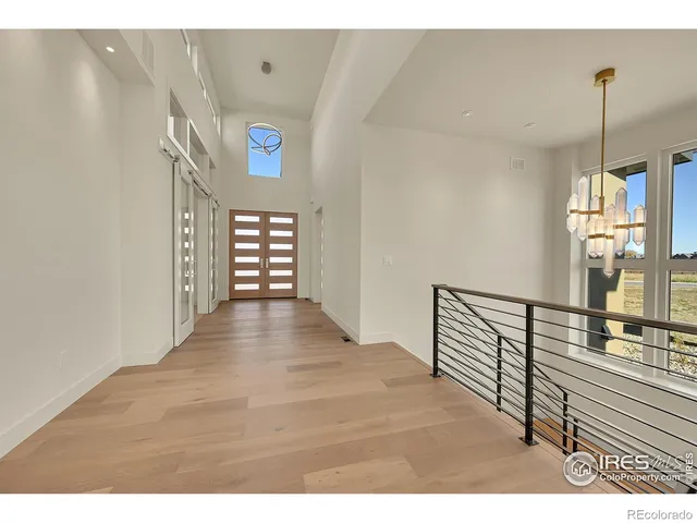 a view of an entryway with wooden floor