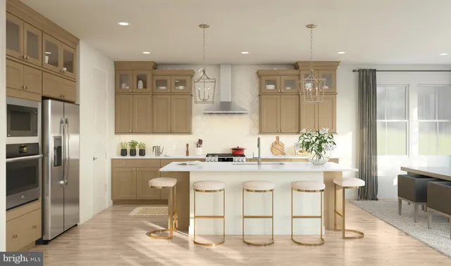 a kitchen with stainless steel appliances granite countertop a stove top oven a sink refrigerator and chairs